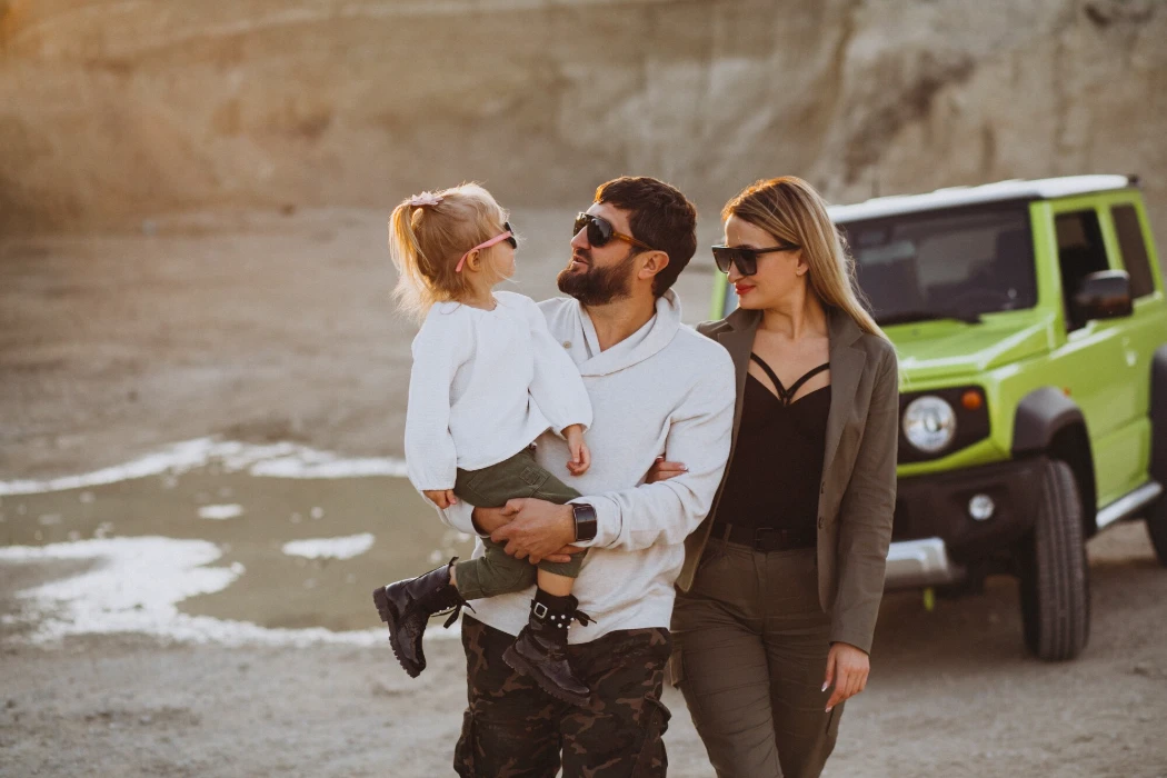 Young family with little daughter travelling by car